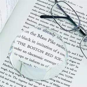 Not only is this a paperweight, but it's a magnifying glass too. Slide the paperweight over that hard-to-read small print and the 2x magnifying glass will bring the letters to a readable size. This paperweight measures 3" in diameter. Packed in a black gift box with white satin lining.