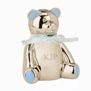 This cute teddy bear bank is a perfect gift for that special little boy. The teddy bear is bright silver and is nickelplated so it won't tarnish. The teddy bear has blue highlights on its ears and feet and a blue ribbon tied around its neck. The coin slot it behind the bear's head and the removable black stopper is on the bottom of the bank. The bank is 4" h x 3.75" w. Gift Boxed.