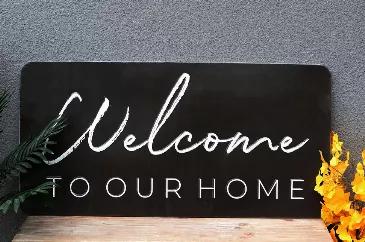 Large Welcome To Our Home Embossed Metal Printing Wall Sign Decor<br> <br> Size: 36.25"W x 0.375"D x 18.125"H<br> Material: Iron<br> Color: Black<br> Sign Message: Welcome To Our Home<br> <br> Includes hangers on the reverse side for easy wall application and alignment.<br> Decorative metal sign featuers embossed white sentiment that reads "welcome to our home" on classic black background.<br> The design is permanently printed on the metal and will not chip, peel, or fade.<br> An ideal gift for 