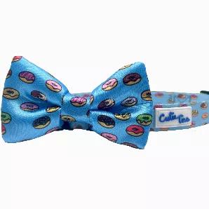 <p>Mmmm donuts... High quality, thickly sewn dog bow tie. All bow ties are 2" x 4" and fasten securely over any dog collar easily with the two elastic loops on the back of the bow tie - as seen in pictures. *Collar not included.</p>