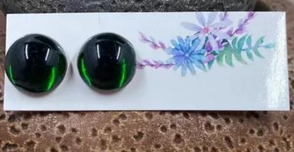 These handmade studs are made with vintage green glass embellishments with foil background and stainless steel posts. Approximately 11mm.