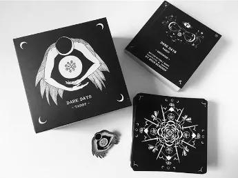 Take your intentions with you after a reading with this queenly combo.<br>
Created by Wren McMurdo Brignac Classic Matte Dark Days Tarot Deck<br>
78 black and white Tarot cards - 350 gsm art paper, matte UV finish<br>
180-pg. flip guidebook<br>
The lidded box with ribbon Printed in on FSC Certified paper using soy-based inks <br>
<br>
Queen of Pentacles Enamel Pin is 1.25" diameter with a double-back design to prevent swiveling. <br>
The Dark Days Tarot deck is inspired by the dark days of the l