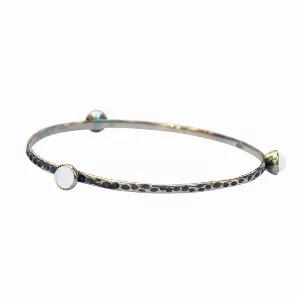 <p>Hammered .925 sterling with three 6mm handmade glass gems surrounding the textured piece.  Can be worn alone or mix and match several for color and jingle!  The bangle measures 2 3/4" wide and the sterling silver is 1/4" wide.  Glass gems are 6mm.  </p><p><strong data-mce-fragment="1">Each piece includes "The Story of the Glass" detailing the history and age of the glass used!</strong><br></p><p data-mce-fragment="1">Available in the following vintage glass colors:</p><ul data-mce-fragment="1
