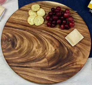 These round charcuterie boards are made from a single piece of East Indian Walnut, no glue joints. Our large round boards are 15" in diameter by a sturdy 1" thick. Each board comes with convenient finger reliefs on the backside. Hand crafted, these boards are perfect for serving charcuterie, appetizers, or highlighting entrees but can also double as a unique cutting board. 