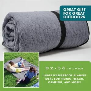 Large waterproof outdoor blanket has a 4-layer design to provides extra warmth and comfort. The blanket features 2 loops and pegs in each corner of the blanket which provides a double level of security when attaching it to the ground. The blanket also features an elasticated strap along the shortest side to assist with folding it up and placing it into the portable, draw-string bag.<br> <br> Use our blanket in all locations and all seasons: at the park, beach, camping, outdoor concert, festival,