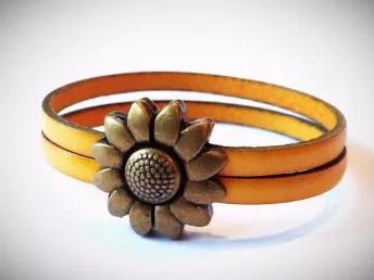 Each bracelet is made with two strands of genuine leather and an antique brass magnetic flower clasp. This listing is for a child's size - 5.5 inches.