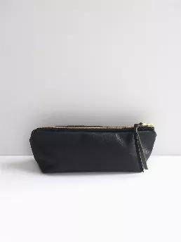  Slim silhouette leather pouch--Leather pouch for your everyday makeup essentials or use as a pen/pencil case. Made with soft black leather and lined with black cotton fabric. Features a matching leather zipper pull. 
Details:
Genuine black leather
8" long x 3.25" h  x 2" d
Interior lined with black cotton
Gold tooth metal zipper entry
