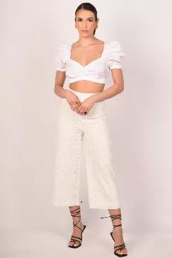 <p style="text-align: left;">A modern ensemble crafted with an eyelet fabric in classic white color.  The pants have a fitted silhouette contrasted with wide hems. </p><div style="text-align: left;">Material: </div><div style="text-align: left;"><br></div><div style="text-align: left;"><br></div><div style="text-align: left;">Cropped hem</div><div style="text-align: left;">High-waist</div><div style="text-align: left;">Lined</div><div style="text-align: left;">Made in Turkey</div>