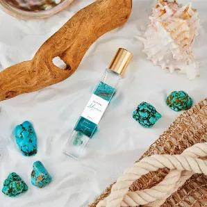 <p>Sunkissed notes of golden amber & oceanic musk elevate your beachy vibe, while glimmers of exotic coconut surrender your aura. Infused with natural essential oils; glass bottle is adorned with genuine amazonite & turquoise gemstones {the soothing stones that enhance love}.</p>
golden amber | oceanic musk | exotic coconut  <br> How to Use: <br>

<p>The pure essence oil imparts a richer aroma that remains close to your skin, and is to be applied to your pulse points. For best aromatic results, 