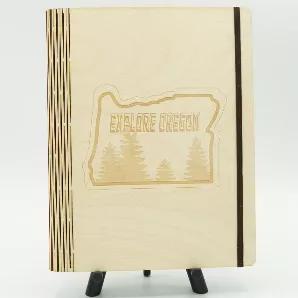 7.75 wide x 10 tall, 80 lined pages inside, cover made of one solid piece of baltic birch wood