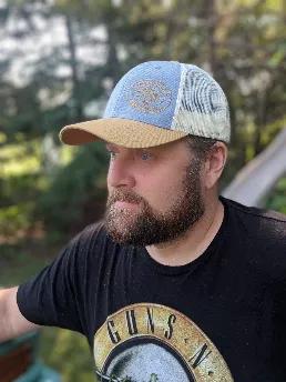 <p>At Unruly Beard, we believe a good cap is more than just headware, it tells a story!  </p>
<p>If you're a fan of who we are and what we do, why not rock our new apparel? </p>
<p>We designed this denim and camel colour block cap to have <span data-mce-fragment="1">embroidery detailing of our logo in the front so you can </span>boast your Unruly Beard clan status to the world without it lookin' ugly. </p>
<p>For added breathability, it features white mesh in the back - making it the perfect add