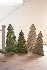 Almost as large as life, these Christmas trees are ready to make a bold statement among your Holiday decor! This wooden set is adorned with colorful ornaments that require no hanging. With a display stand attached to the back, these trees can rest anywher