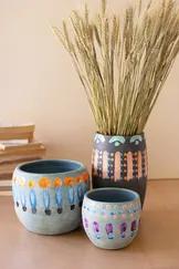 Add an eye-catching pop of color with this set of three hand painted vases/bowls. The unique colorful patterns will bring a fun vibe to your space!