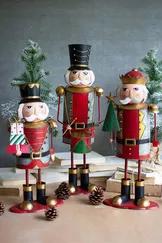The colorful metal nutcrackers may be a set of three but each are unique and can stand alone! The largest is featured playing a drum, the middle is displaying a Christmas tree and the smallest is carrying all of the wrapped gifts.
