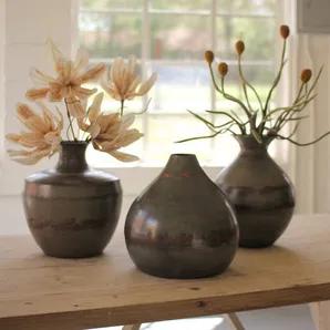 This set of 3 vases with metal and copper detail make a statement in your home.  They look great on a shelf and give that contemporary look that people love.