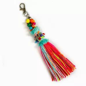 This bag charm has multi-colored beads, charms and a tassel. It will add a bit of sunshine to your bag, with its vibrant colors.