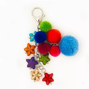 This delightful bag charm has 6 different colored pom-poms along with multi colored stars. Multi colored.