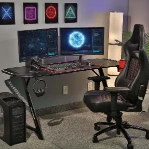 The Aggro Z-shaped gaming computer desk is designed to elevate your game and maximize your success. Providing a large, ergonomic surface, the Aggro gaming desk is perfect for gamers who like to spread out in the heat of battle. Its solid build features steel tube, z-shaped framing and a carbon fiber laminated desktop that can support multiple monitor setups, keyboards, mice, and any other accessories needed for epic gaming. The Aggro also features a discreet cable management system for hanging c