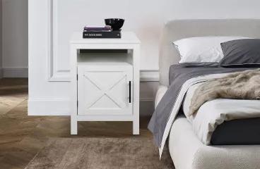 Decorate your home in a casual, farmhouse style with this charming side table. Build your bedroom ensemble from the ground up with this piece, offering the perfect perch for all family photos and storage space inside for nighttime essentials. The single door steals the show, showcasing an "X-shaped" front and metal handle.  