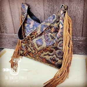 <p><span style="font-weight: 400;">Channel the spirit of the Southwest with this boho handbag from Jewelry Junkie! Featuring a bold, Navajo-inspired print, this crossbody bag is sure to leave an impression.</span></p>
<ul>
<li style="font-weight: 400;"><span style="font-weight: 400;">Made from genuine leather </span></li>
<li style="font-weight: 400;">Fully lined with genuine leather</li>
<li style="font-weight: 400;"><span style="font-weight: 400;">Hidden Snap Closure</span></li>
<li style="fon