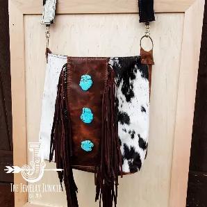 <p><span style="font-weight: 400;">Channel the spirit of the Southwest with this boho handbag from Jewelry Junkie! Featuring a bold, black and white hide, this crossbody bag is sure to leave an impression.</span></p>
<ul>
<li style="font-weight: 400;"><span style="font-weight: 400;">Made from genuine leather </span></li>
<li style="font-weight: 400;"><span style="font-weight: 400;">Fully lined</span></li>
<li style="font-weight: 400;"><span style="font-weight: 400;">Magnetic Snap Closure</span><