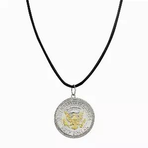 The Presidential Seal is the focus of this JFK Half Dollar Pendant and is selectively layered in gold. A genuine United States JFK Half Dollar is set in a sterling silver rope bezel and hangs from a leather cord 18 inch necklace with a 2 inch extender and lobster claw clasp. The JFK Half Dollar minted from 1964 to present and the reverse was designed by Frank Gasparro. A Certificate of Authenticity is included. Years and mint marks will vary.