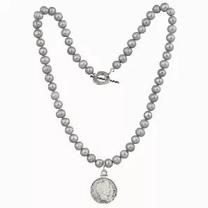 A genuine silver Barber Dime pendant combined with classic cultured silver grey pearls makes a sophisticated statement. A silver Barber Dime minted from 1892 to 1916 stays secure in a sterling silver bezel and hangs from a double hand knotted silk thread strand of cultured grey pearls. The 18 inch pearl strand features 7mm round cultured silver grey pearls with a heart shaped rhodium plated toggle closure. The silver Barber Dime was designed by Charles Barber and features Lady Liberty with wreat