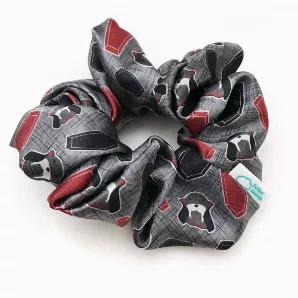 Satin scrunchie featuring Walter the walrus wearing his vampire costume on a gray background with black and red coffins.<br>The silky satin fabric makes for a snag-free hair experience. Wrap around a ponytail or bun for a fun pop of Halloween season spirit.<br>Inner elastic stretches from approximately 2" to 7" wide. The whole scrunchie measures approximately 5" in diameter when unstretched.