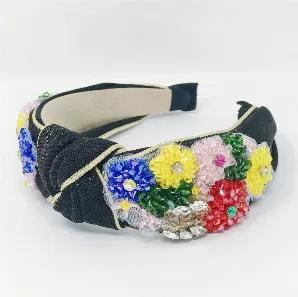 This headband has all the beautiful details! Detailed with black shimmer fabric, gold trim, and unique beaded flowers! <br>Soft end edges for comfortable wear. <br>Dimensions: approximately 7" x 6" x 2"<br>Made in China<br>