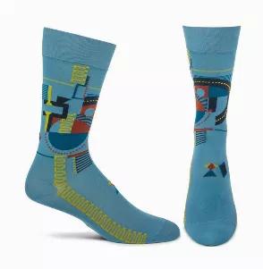 <p>Incorporating fire, earth and water, this abstract design is adapted from the fireplace mural design at the center of Frank Lloyd Wright's Hollyhock House.</p> <p>Men's dress crew sock from Ozone Design inspired by the designs of Frank Lloyd Wright. Made in Japan. Contents: 100% Nylon. Men's sock size 10-12 (shoe 8-12.5).</p>