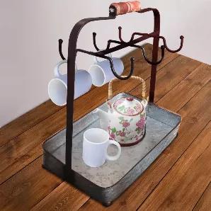 Bring this crockery holder home and add a rustic charm to your settings. Made from galvanized metal sheet, this crockery holder features six symmetrical cup hooks along with attached rectangular basket. With a weight capacity of 4.5 pounds, it makes a great tea time accessory that provides you enough space for holding tea pots, milk, sugar and cups. The handle at the top is made from wood that provides a great portability while moving it from one place to another.