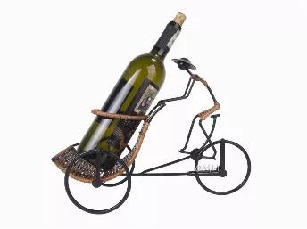 <p>Present and transport wine in effortless fashion with the Asian Style Rickshaw Cyclist Wine Holder. The elegant rickshaw and driver figurine are both fluidly handcrafted from metal and finished with wrapped rattan. At 14.17 x 6.3 x 10.24 inches, it is sized for easy use and equally easy on the eye for any table arrangement.</p>