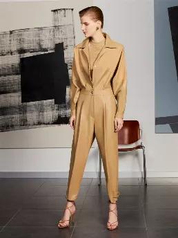 <p>Lapel collar faux leather jumpsuit with cuffed long sleeves. Metal snap buttons and zip closure at front. Pleat detail at waistband and sleeves. Epaulettes at hem.</p>
<p>Mix and Match: A collection that matches knitwear and denims with knitted and woven fabrics: It is a wonderful mix-and-match of unique designs. Casual styles in bright hues will bring a solution and a bright smile to your every day.</p>
<p>Torso: 59% PVC, 39% Polyester, 2% Polyurethane Trimming: 72% Polyester, 22% Viscose, 6