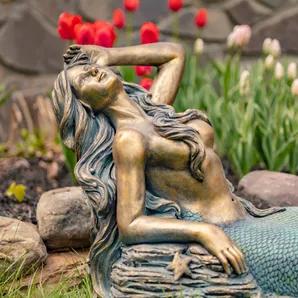 Bring the fantasy home with the Zaer Ltd. Mermaid Garden Statues. Crafted from quality magnesium, our mermaid statues features complex textures and unique hand painted finishes making each piece one of a kind. The muted teal green contrasts with the antique metallic bronze creating a dynamic structure that is guaranteed to impress. Camree features long flowing hair that gently conceals her chest as she leans back against a rock to sunbathe <br><br>- Indoor/Outdoor<br>- 100% quality magnesium<br>