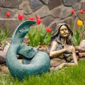Bring the fantasy home with the Zaer Ltd. Mermaid Garden Statues. Crafted from quality magnesium, our mermaid statues features complex textures and unique hand painted finishes making each piece one of a kind. The muted teal green contrasts with the antique metallic bronze creating a dynamic structure that is guaranteed to impress. Finnleigh features long flowing hair that gently conceals her chest while she lays on the sand, flicking her beautiful tail. <br>- Indoor/Outdoor<br>- 100% quality ma