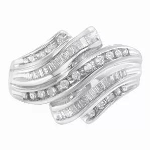 A diamond band that glistens with five rows of alternating channel set round and baguette diamonds in a serpentine shape. The band is crafted in cool 10 karat white gold and has a total diamond weight of 3/4 carats.