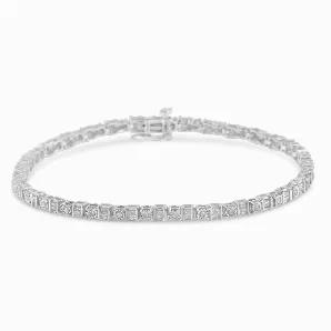Feminine and delicate, this diamond tennis bracelet is the perfect gift for any occasion. Crafted from 10k white gold, this piece is embellished with 66 baguette diamonds and 33 round diamonds. 99 diamonds come together to create a stunning 1 ct tdw bracelet. Illuminate her wrist with this stunning piece, which serves as a beautiful accessory to any outfit, casual or formal.