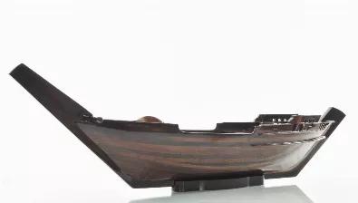 Length: 27
Width: 5.5
Height: 8.5
For many centuries, boats that sailed on the Indian Ocean were called dhows and were distinguishable from ships that sailed on the Mediterranean or China Sea by the shape of the Dhows triangular sails. This wooden tray is an exact replica of the Dhow boat, the famous boat that sailed on the Indian Ocean. It can be used to serve foods or display as a unique decoration for your house. It would add a touch of nautical yet elegance to your homes dining table. It 