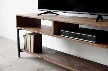 Length: 16 Width: 60 Height: 24 Craft the ideal blend of style, function, and design with this mid-century modern style TV stand. It is a classy piece, made of high quality maple and steel. Its chocolate color and finish are nothing to scoff at either. This TV stand an ultimate instrument to present a bit of freshness into your place. This TV stand also blends being overall stunning with being practical. Beyond just being perfect for your TV, there is no better place for your video collections, 