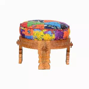 Add charm to your home furnishing with this vibrant Ottoman Footrest showcasing rich colors with a traditional design. Elegantly handcrafted from Mango wood and comes with a multicolor cushioned top with fabric upholstery and finished with piping details that complement the overall look. The round wooden base with four legs incorporates beautifully carved detailing with grain details and a brown finish. Perfect to be placed in your living room, bedroom, or balcony, this ottoman can be used as a 