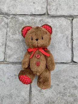<p>Handmade dark&nbsp;brown teddy bear with red ear and foot detail, two buttons and a bow.&nbsp;<br />
<br />
Made according to old European patterns. Heirloom quality.<br />
<br />
The plushie&nbsp;has movable arms and legs and can easily sit on its own. Great for imaginative play or just a great addition to your collection!&nbsp;The eyes and nose are embroidered.&nbsp;<br />
<br />
Measures 6in. standing up.&nbsp;<br />
<br />
Due to small parts, NOT SUITABLE FOR CHILDREN 3 AND UNDER.