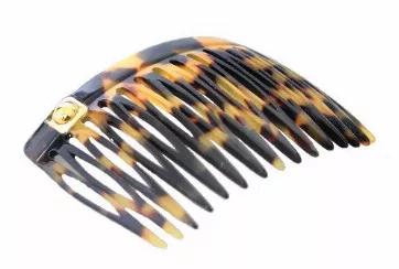 <p>Handmade side hair comb in Tokyo print decorated with square metal stud and gold ball.</p> <br><tr><th>Material:</th><td>Celluloid </td></tr><br><tr><th>Manufacturer:</th><td>French</td></tr><br><tr><th>Hand made plastic:</th><td>Yes</td></tr><br><tr><th>Hand painted:</th><td>No</td></tr> <tr><th>Style:</th><td>Day/Evening</td></tr>  <tr><th>Size:</th> <td>Large</td></tr> <tr><th>Width (Inches):</th> <td>0.75</td></tr> <tr><th>Style #:</th> <td>2118</td></tr>