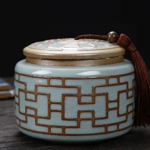 <p>Ceramic decorative tea caddie with tassel<br /> Moisture resistant, tight seal<br /> 100mm x 125mm</p>