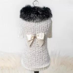 Just in time for the change of season, keep your baby stylish and warm in our new sweater collection. The high society sweater is made from light soft wool and has a faux mink collar, it is accented with our signature bow.