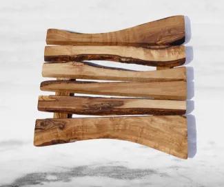 Our trivet is crafted of beautiful olive wood with rich grain unique to each piece. It protects tables and countertops from hot or rough-textured dishes and pans.