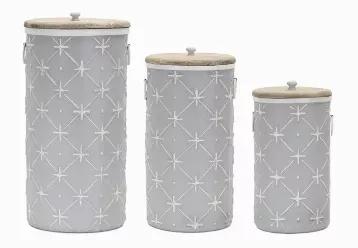 Made from iron and wood Measurements vary between 14 - 20.25 inches in height Comes as a set of 3 These tall floor canisters add interest wherever they are placed. Soft hues of grey and ivory are accented by an embossed pattern. Each features ring handles and wood tops.