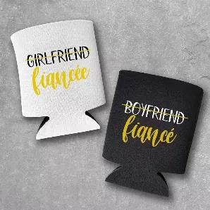 This set of 2 can coolers is the perfect gift to celebrate a newly engaged couple! Perfect for keeping drinks cold while you go over the wedding plans! This is a set of 2 can coolers with one black and one white can cooler, as pictured. <br> -- ENGAGED COUPLE CAN COOLERS - These can coolers are exactly what you've been looking for to keep the beers cold while you plan out the wedding! <br> -- PERFECT FOR THE NEWLY ENGAGED COUPLE - These coolies will get the engagement started off right! <br> -- 