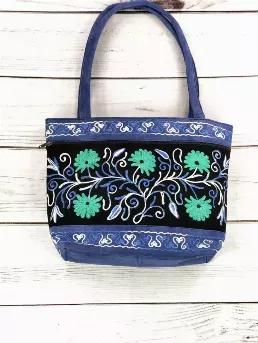 <p>Choose a bag that looks like a work of art!&nbsp; Stylish tote with floral pattern, comes in a variety of attractive color combinations. Is functional and trendy.</p>

<p>Details: Lining inside, zip closure, full face zip pocket on both sides, zip cell pocket.</p>

<p>Size: 15&quot;/11&quot;</p>

<p>Fabric Content - Suede</p>

<p>Care Instructions - Do not wash</p>
