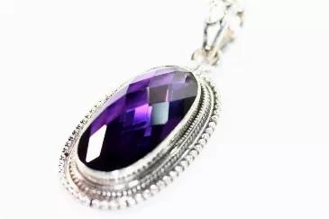 - Fully faceted Deep Purple Amethyst Hue Hydroglass <br>- Sterling Silver Frame with Rope &amp; Bead pattern<br>- A beautiful deep purple Oval<br>- Length is 1.75 inches and the width is .75 inches <br>- Glass size: 14 mm x 25 mm <br>- Total weight: 13.60 grams<br>- Large Pendant