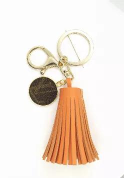 Golden Orange vegan leather tassel keychain with Louis Vuitton Charm. Charm repurposed from LV Speedy 35 FH1912.